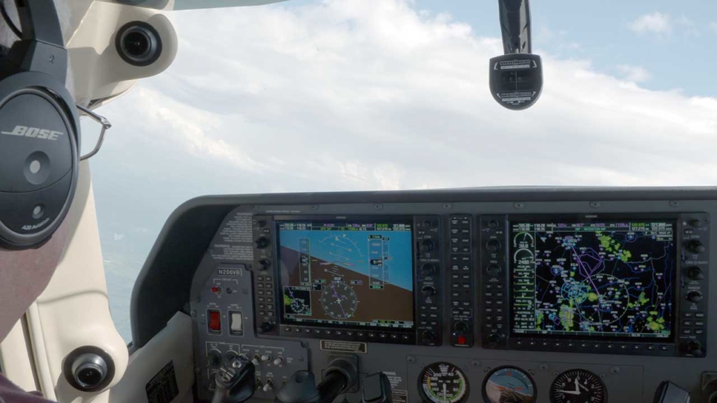 Garmin G1000 equipped Cessna with pilot flying high in the clouds.